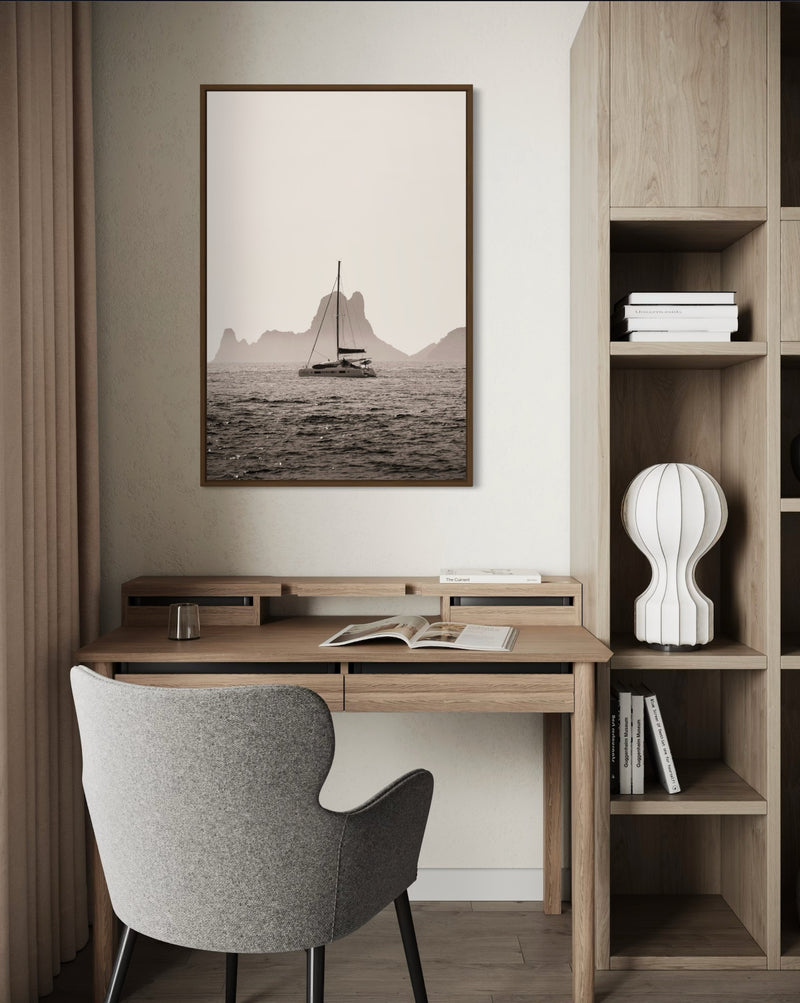 A boat drifting near Es Vedrà, Ibiza, in soft sea haze — fine-art photograph by Kayleigh Groenendijk