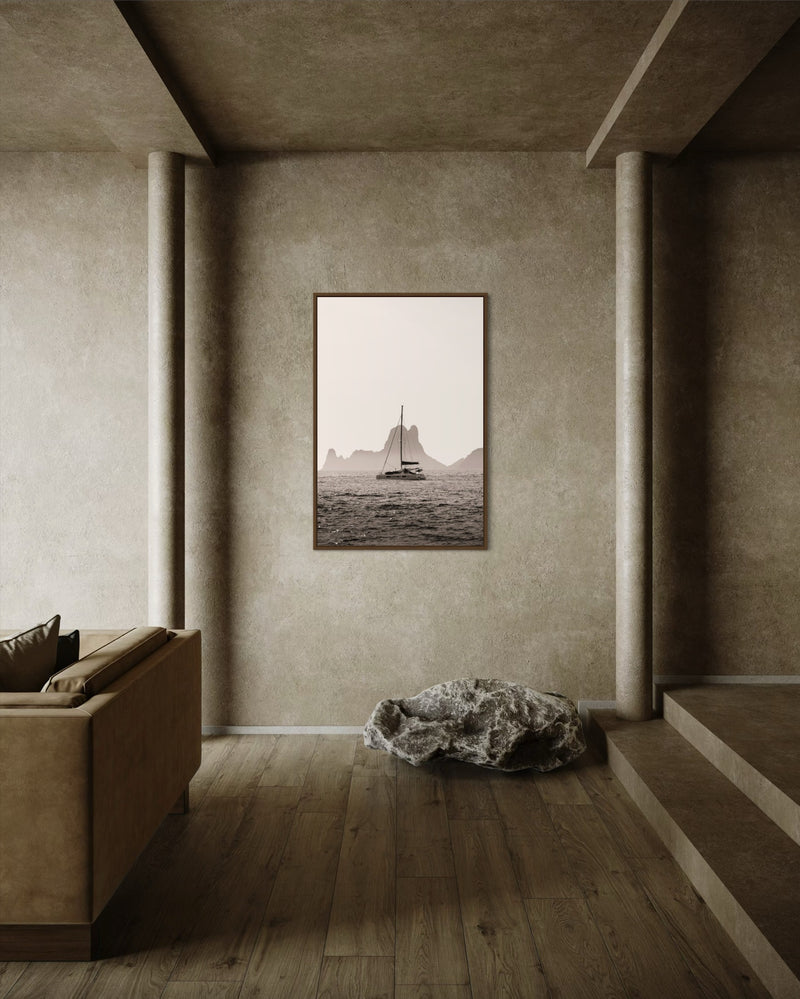 A boat drifting near Es Vedrà, Ibiza, in soft sea haze — fine-art photograph by Kayleigh Groenendijk