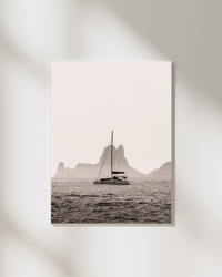 A boat drifting near Es Vedrà, Ibiza, in soft sea haze — fine-art photograph by Kayleigh Groenendijk