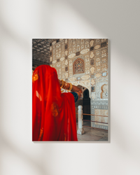 A woman in red stands before a sacred wall in Jaipur India — fine-art photograph by Kayleigh Groenendijk