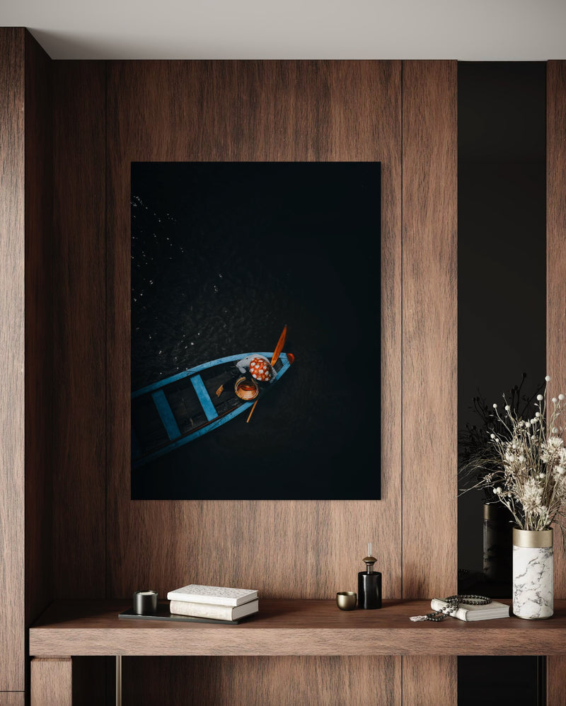Woman drifting in a small wooden boat on a dark river, Vietnam — fine-art photograph by Kayleigh Groenendijk
